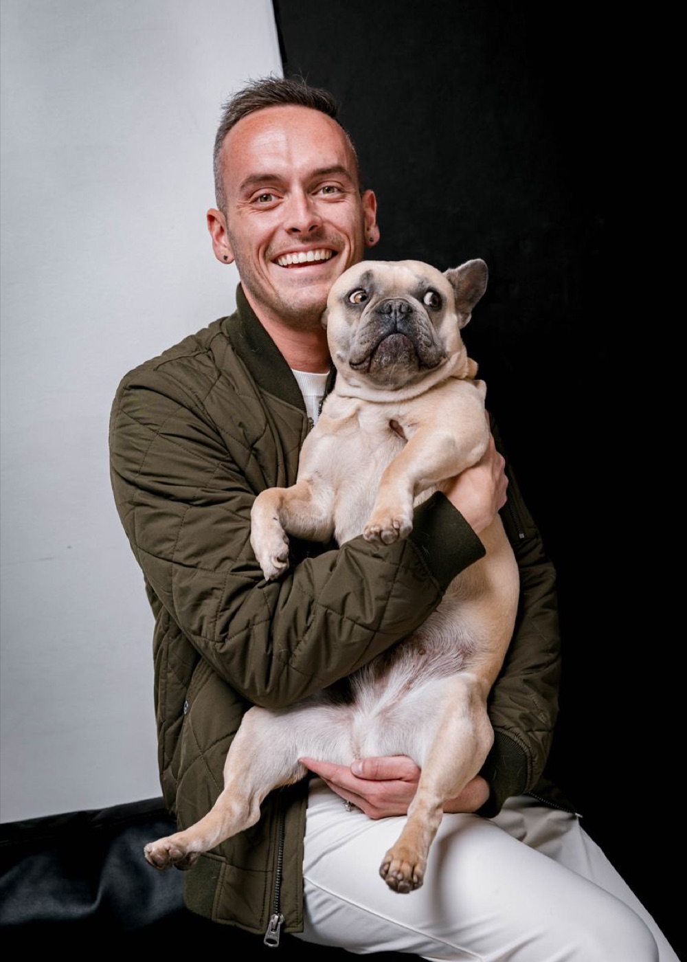 Tyler holding Daisy in his arms