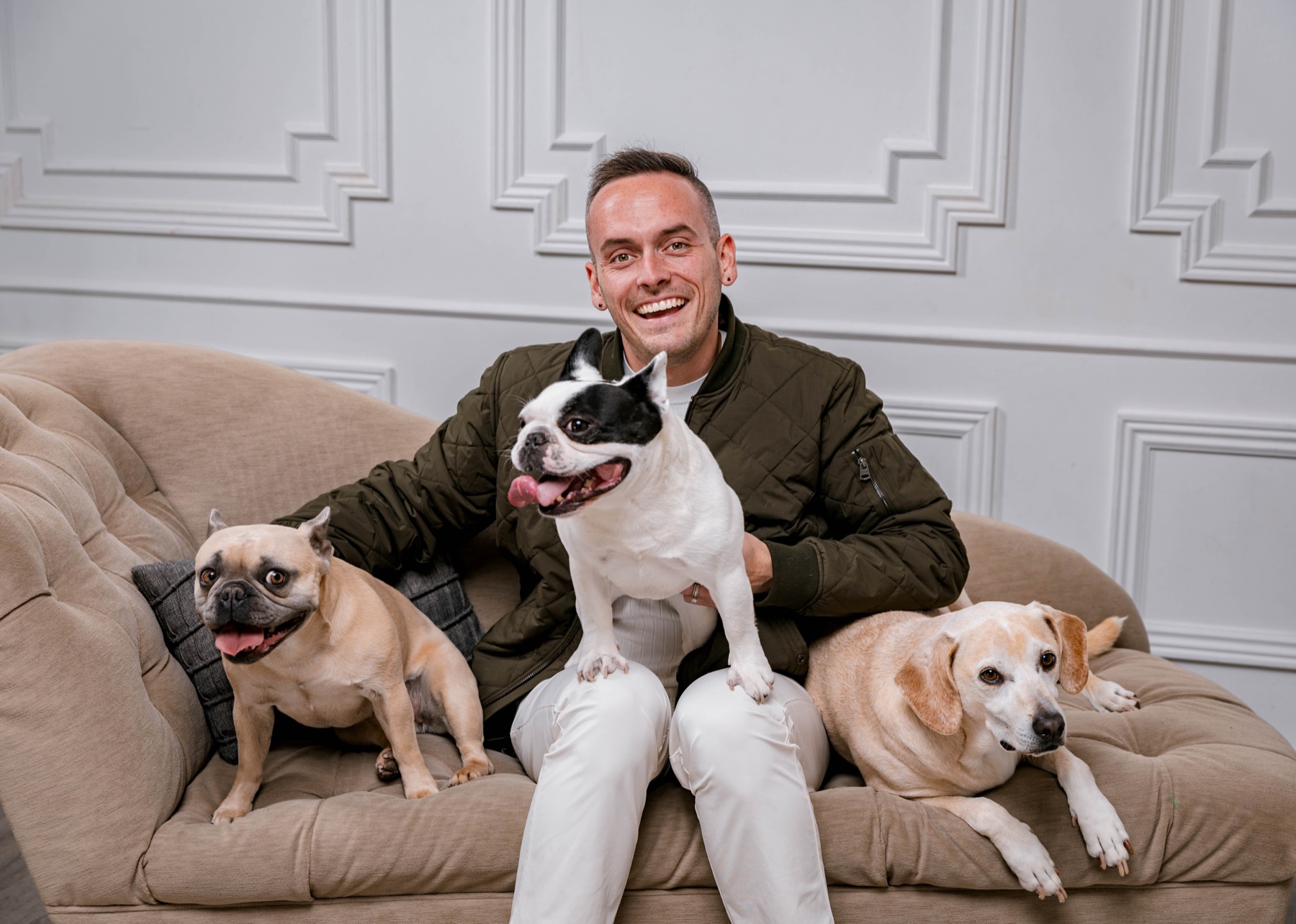 Tyler on a sofa with his three dogs