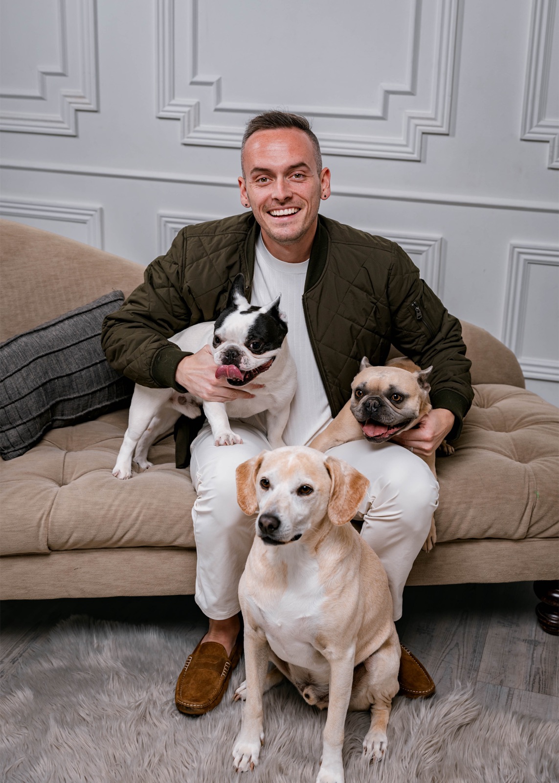 Tyler sitting with his three dogs